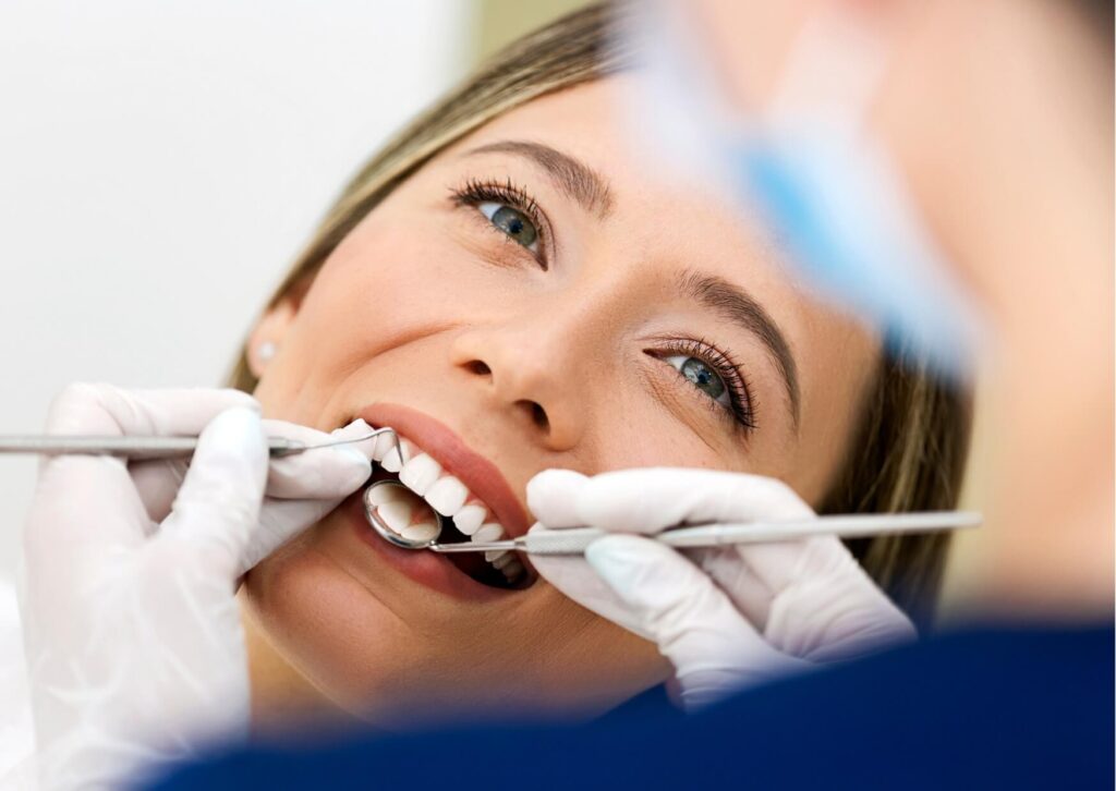 Adult patient receiving a fluoride treatment during a preventive dental visit to help strengthen tooth enamel and reduce cavity risk.